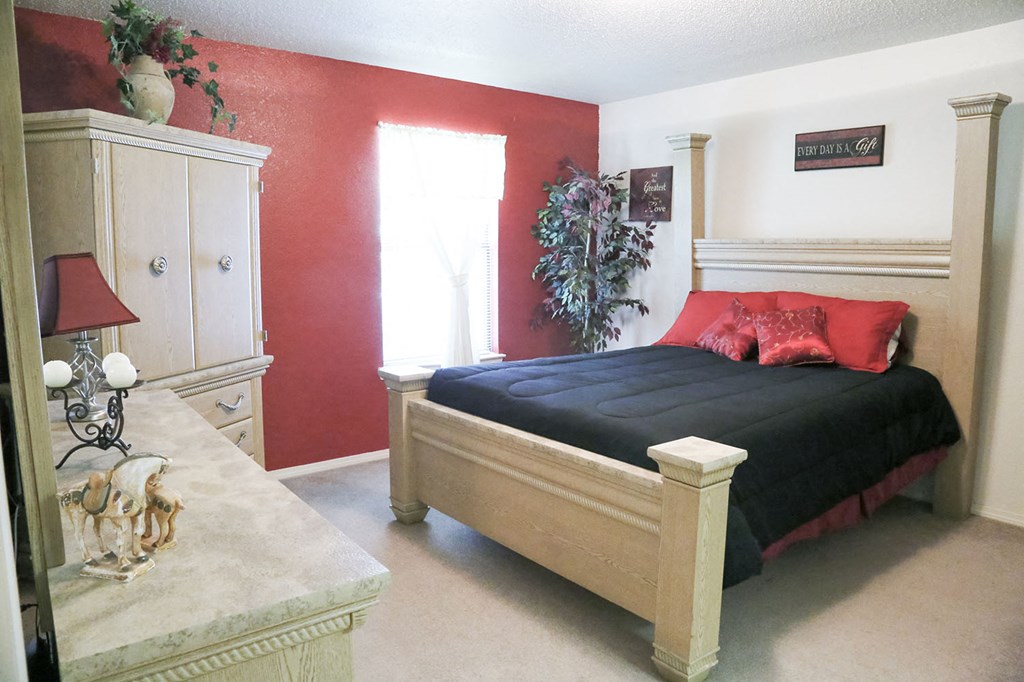 a bedroom with a bed and a dresser