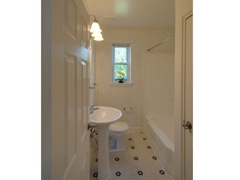 a small bathroom with a sink toilet and shower