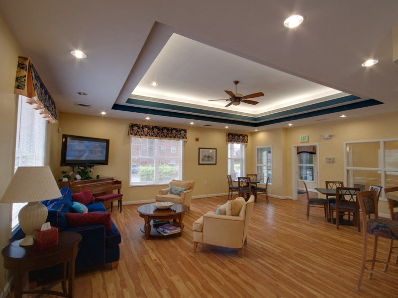 a living room with furniture and a ceiling fan