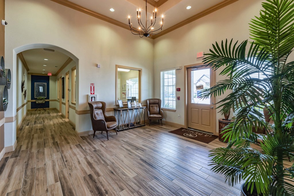 a lobby with a table and chairs and a tree