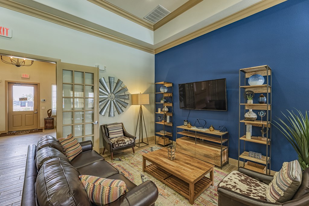 a living room with a leather couch and a tv