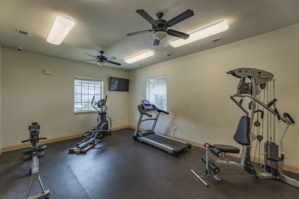 gym with exercise equipment and ceiling fans at the village