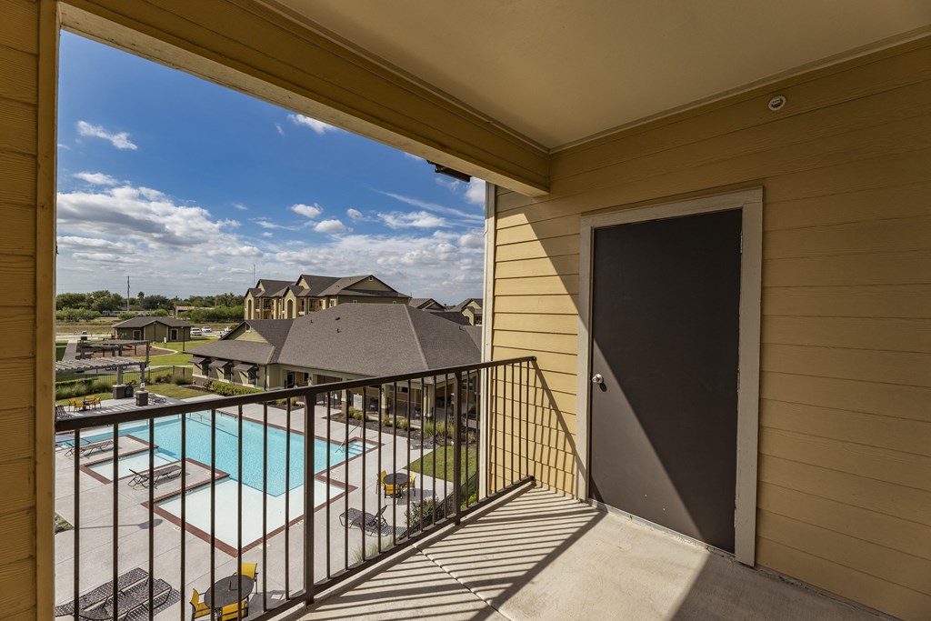take in the view of the pool from the balcony of your home