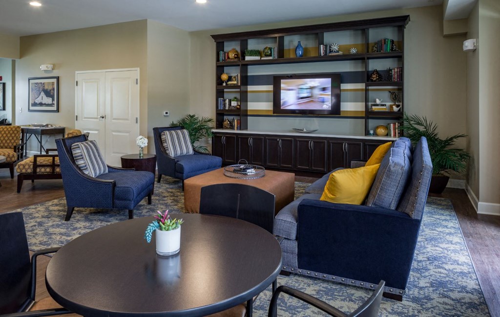 a living room with a table and chairs and a television