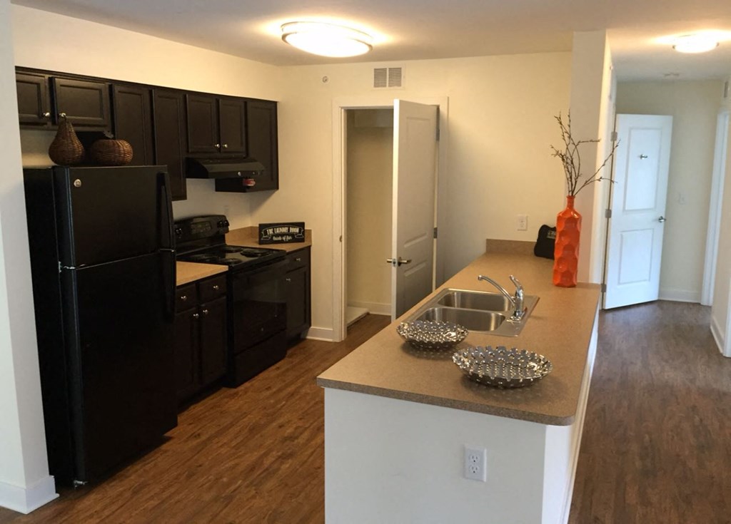 a kitchen with a sink and a refrigerator