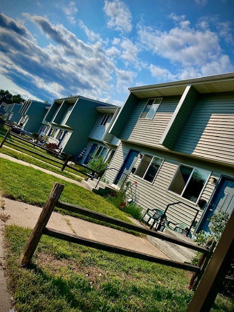 a row of houses with a fence in front of them