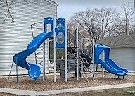 a playground with two sets of blue slides