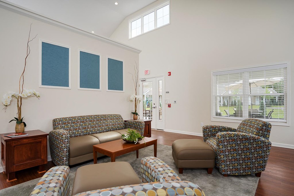 a living room with couches and chairs and a table