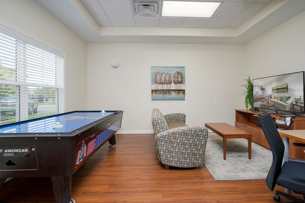 a game room with a pool table and a desk