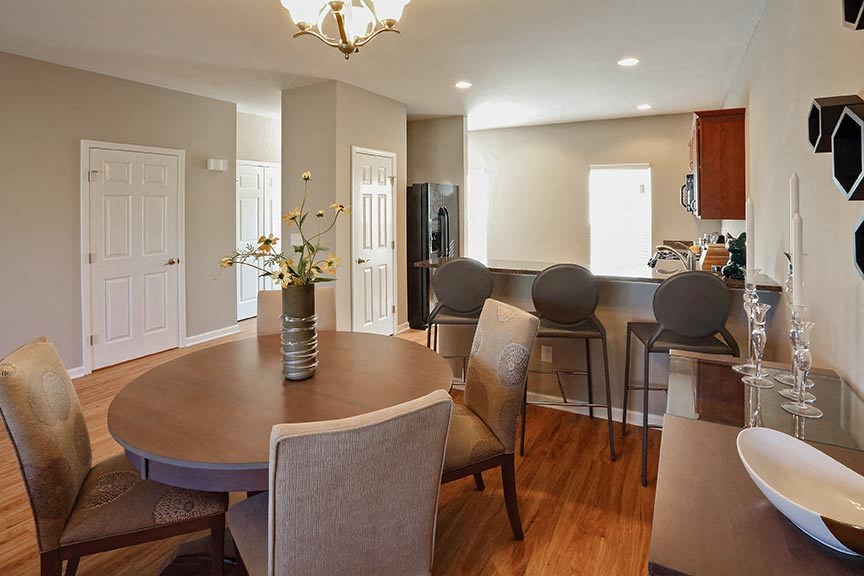 a dining room and kitchen with a table and chairs