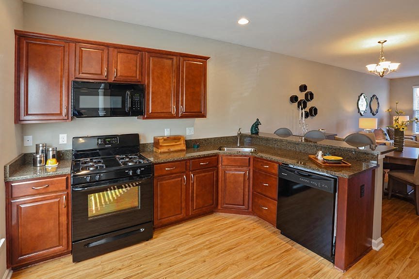 a large kitchen with a stove and a microwave
