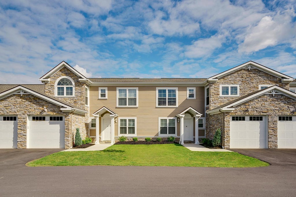 a house with two garage doors and a lawn