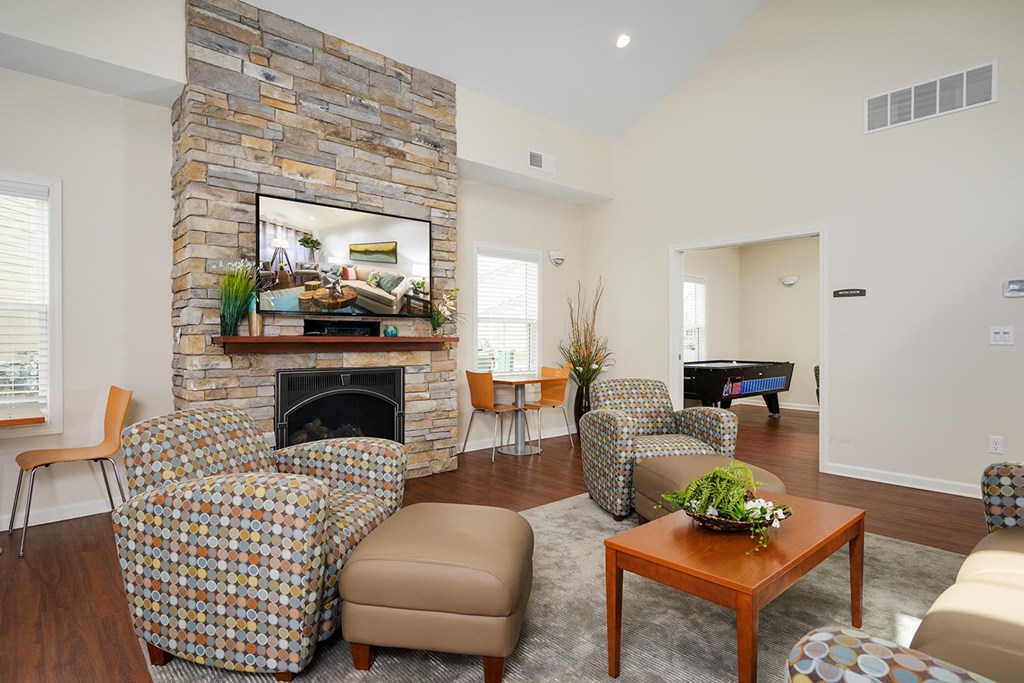 a living room with furniture and a stone fireplace