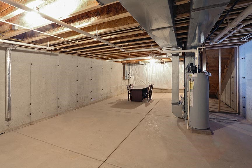 a large unfinished basement with a chair in it
