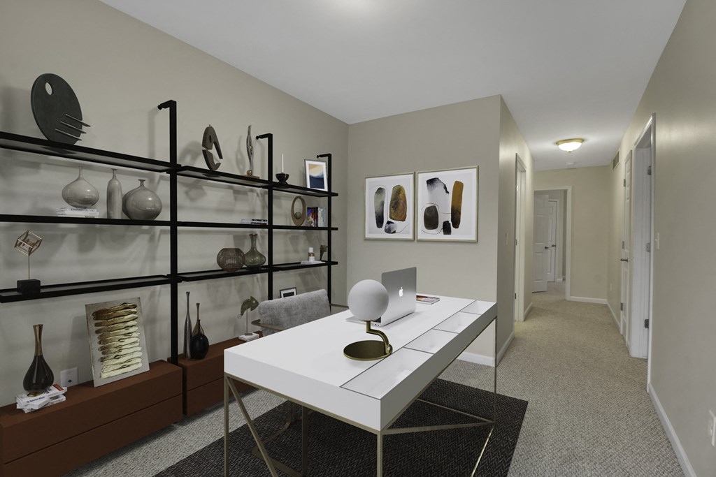 a home office with a white desk and a glass display case
