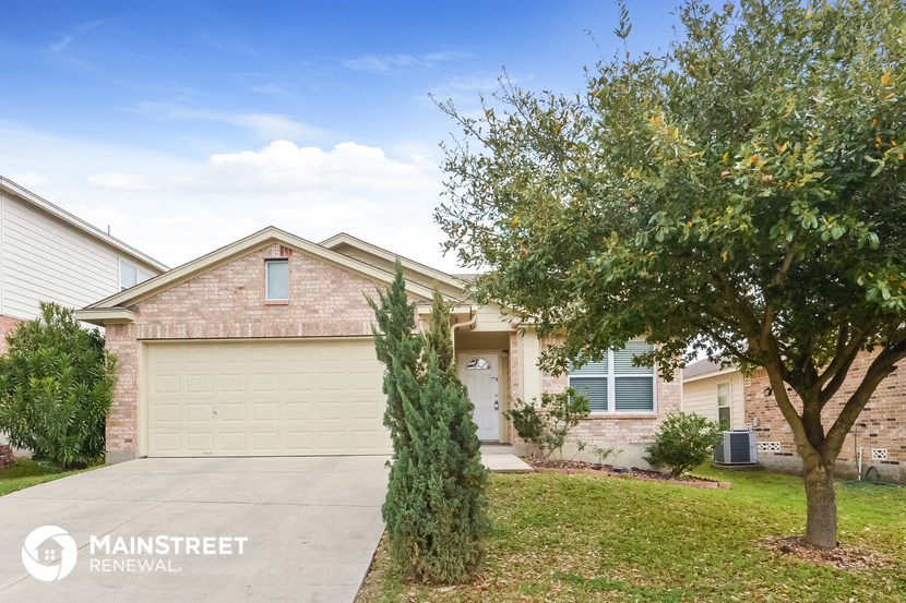 a home with a garage door and a tree