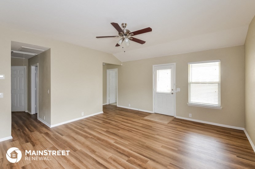 the living room and dining room with wood flooring