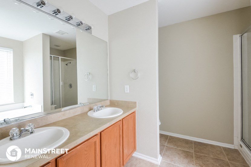 a bathroom with two sinks and a large mirror