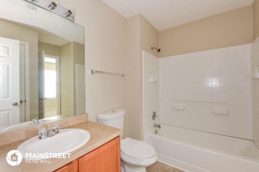 a bathroom with a sink toilet and a bath tub