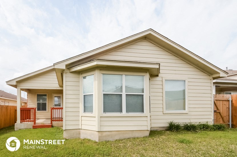 a small white house with white shutters and a porch
