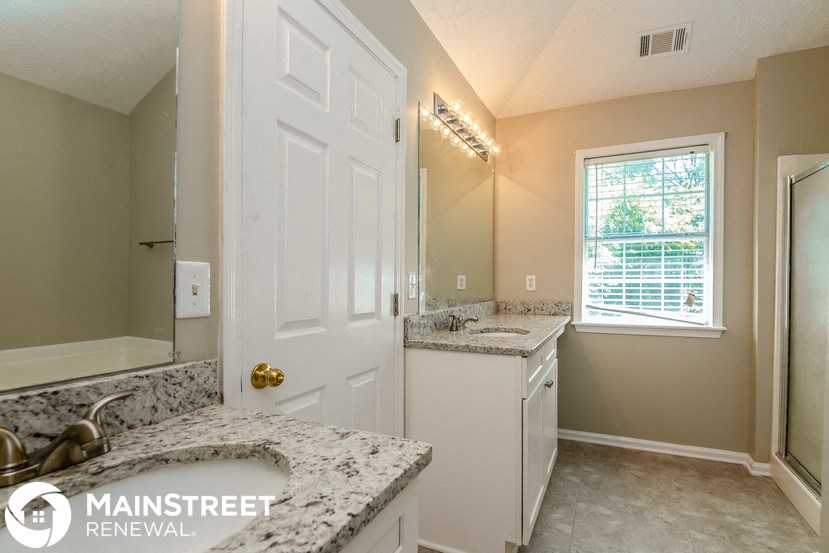 a kitchen with granite counter tops and a white door