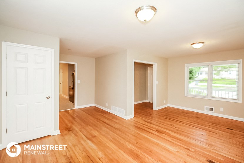 the living room and dining room with wood flooring