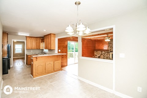 a large kitchen with wooden cabinets and a large island