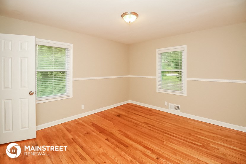 the interior of a home with wood floors and a white door