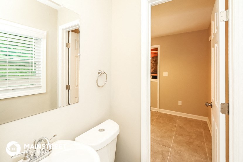 a bathroom with a sink and a mirror and a toilet