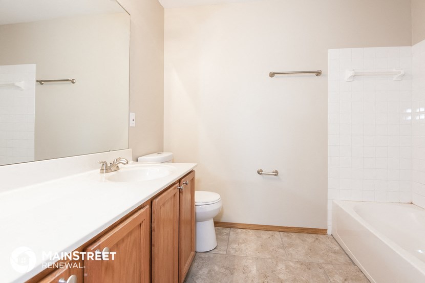 a bathroom with a sink and a toilet and a bath tub