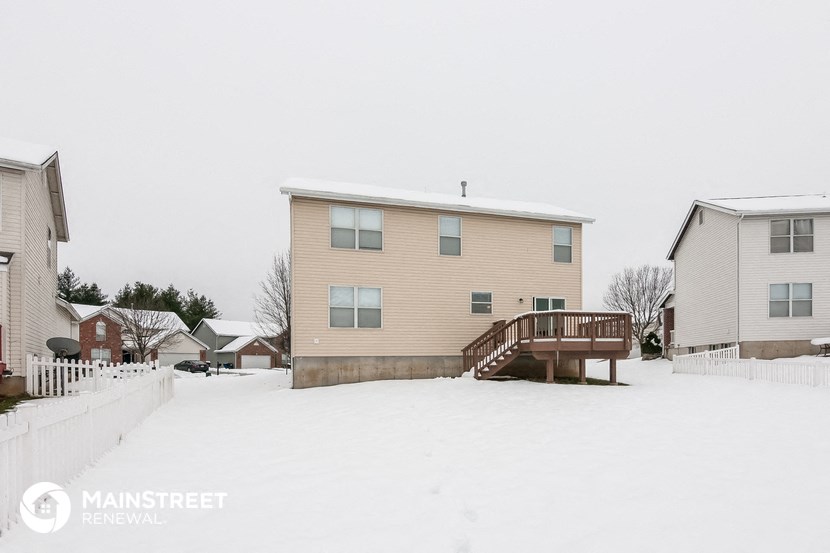 a house with a deck covered in snow