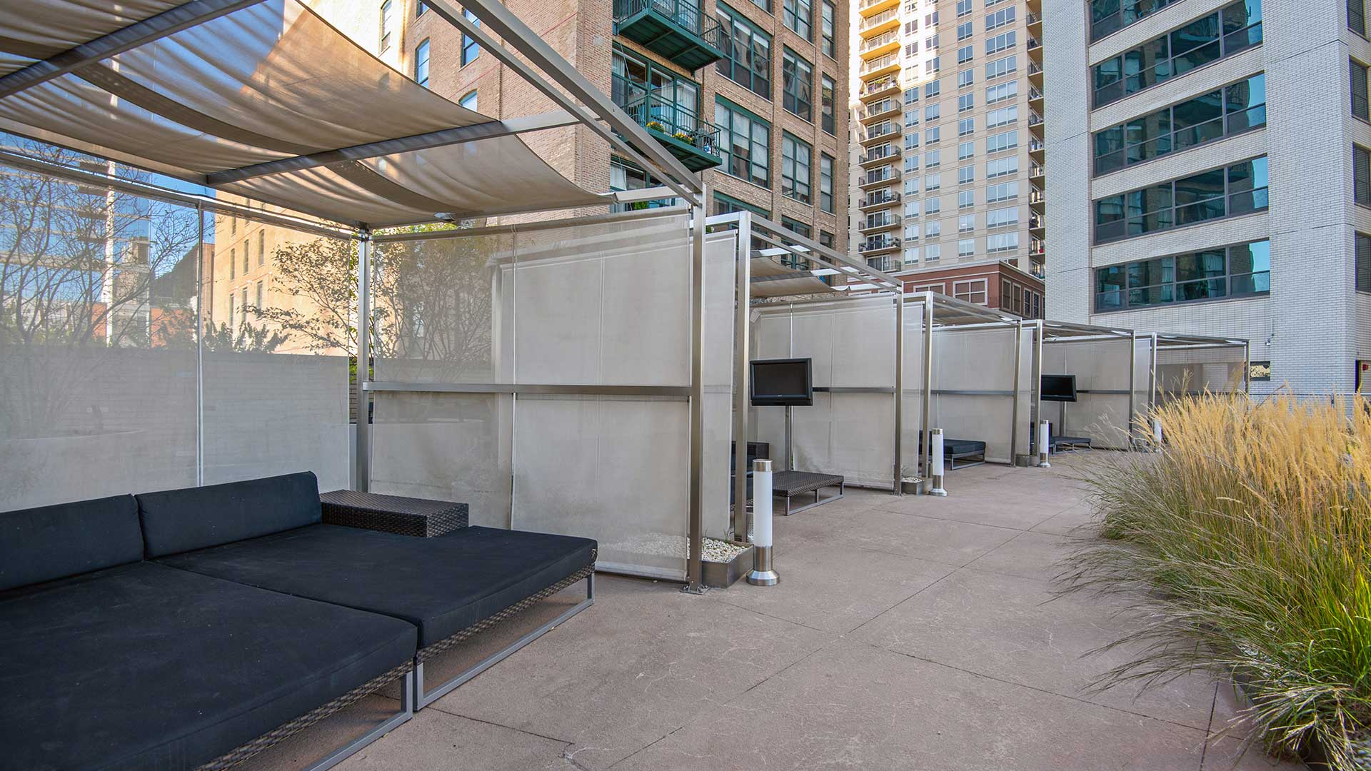 Looking down the row of cabanas poolside at Eleven Thirty. They run along the left and circle around to the right. Each has lounge seating and a television.