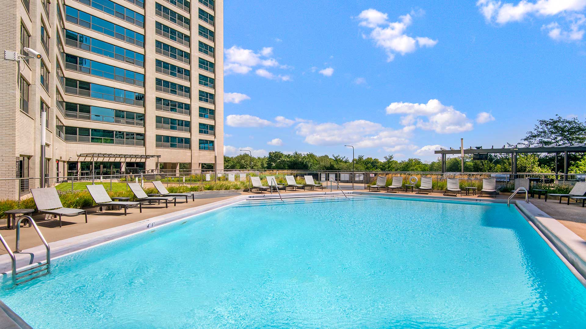 A close view of the outdoor pool and sundeck at Eleven Thirty on a sunny day.