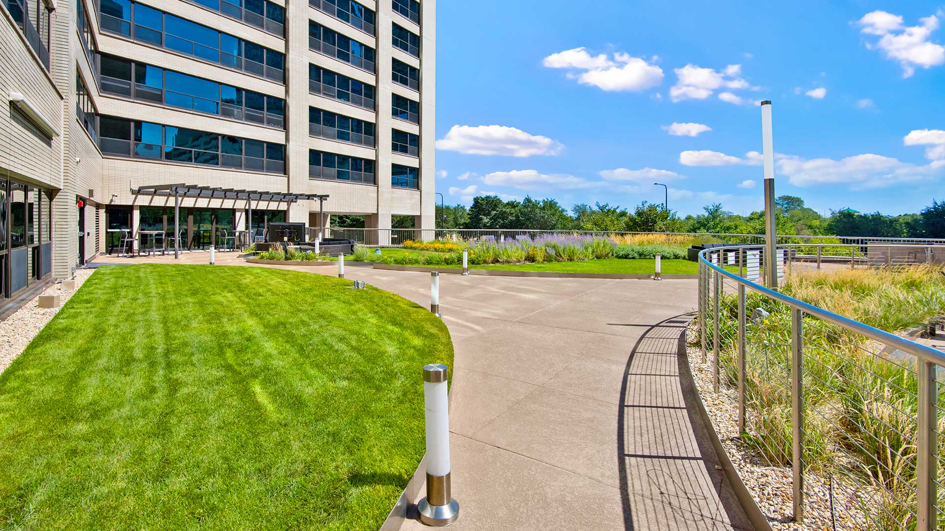 Walkways on the sun deck at Eleven Thirty. The fire pit is off to the left with the apartment tower rising up behind it.