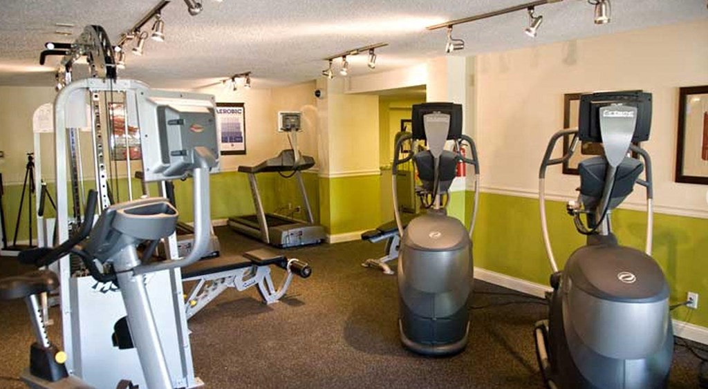 a gym with weights and other exercise equipment in a room