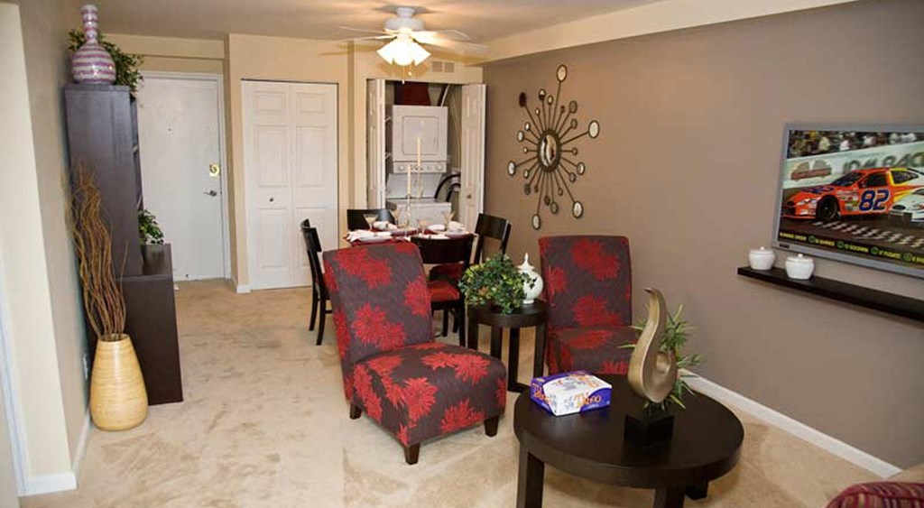 a living room and dining room with a table and chairs