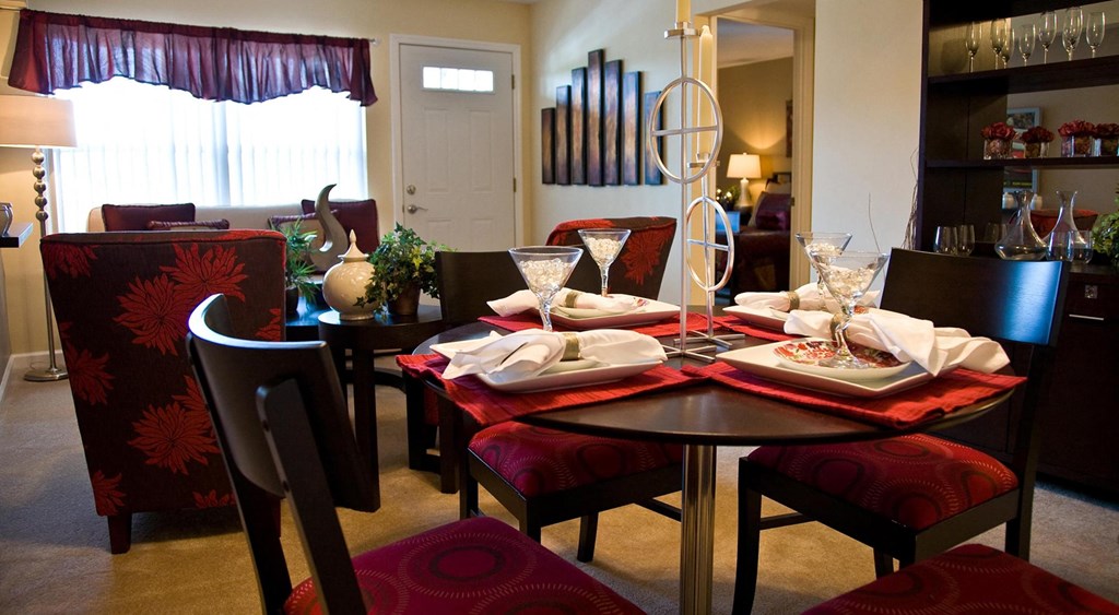 a dining room table is set up for a meal in a living room