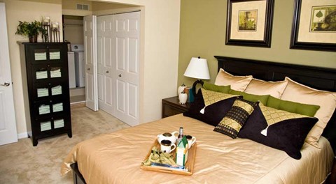 a bedroom with a bed and a tray of pillows