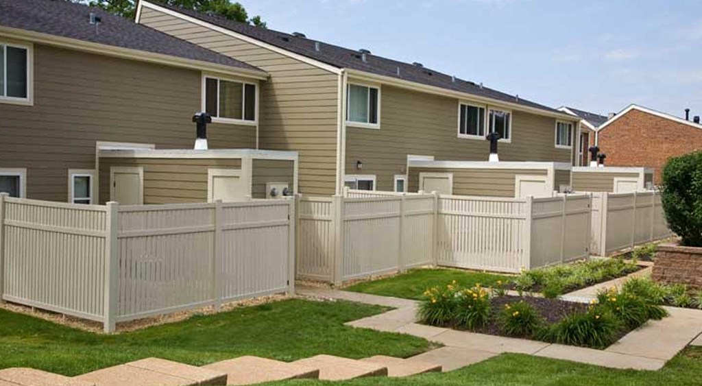 a white fence in front of a house