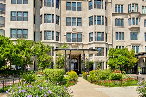 A large building with a black gate and a small entrance.