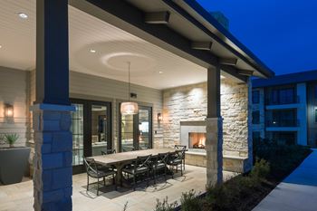 Outdoor Dining Area with Fireplace at Windsor Lantana Hills, Austin, Texas