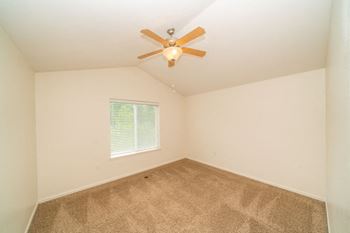 Vaulted Ceiling With Fan in Master Bedroom at Lynbrook Apartments and Townhomes in Elkhorn, NE