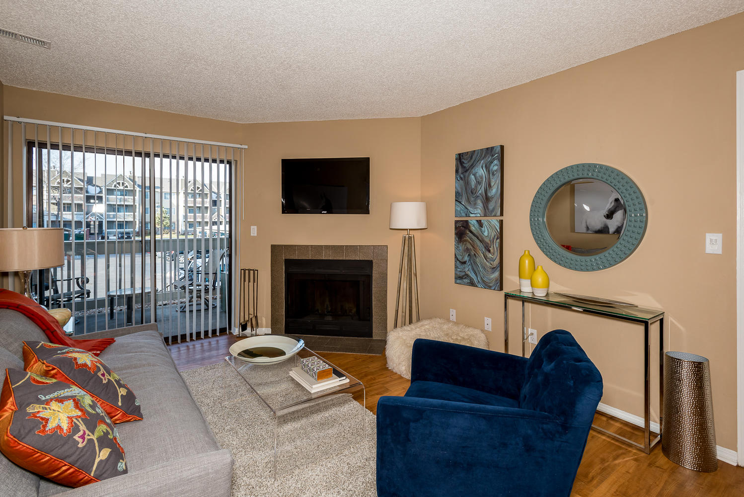 Living Room with Fireplace at Apres Apartments in Aurora, CO