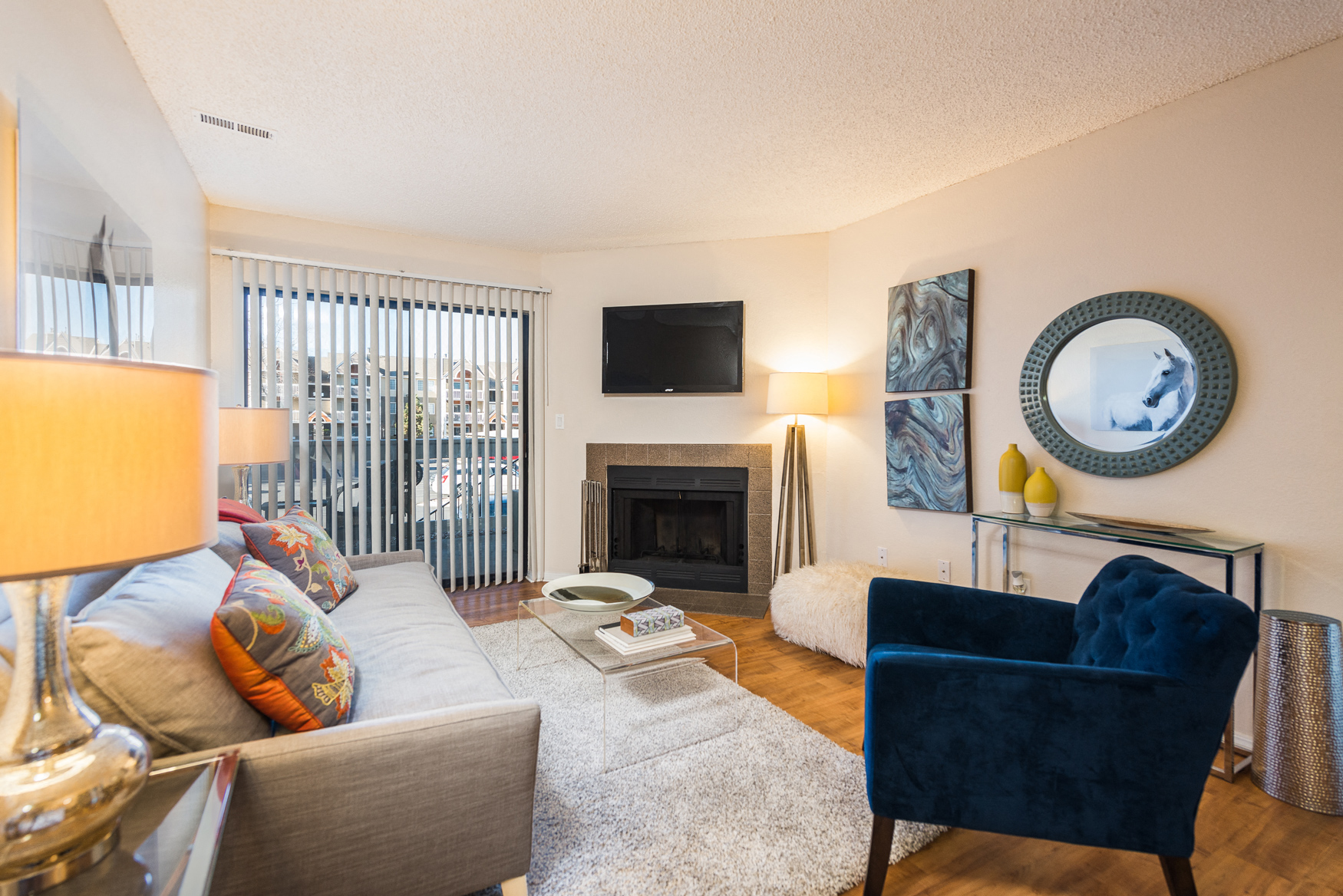 a living room with a couch and a chair and a fireplace