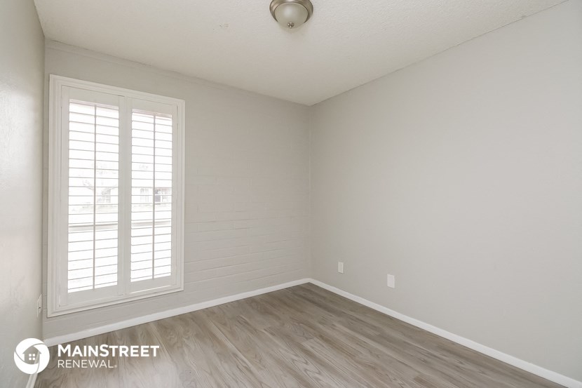 the interior of an empty room with white walls and wood floors