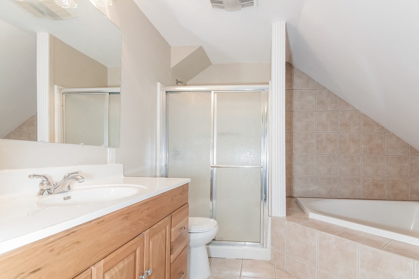 a bathroom with a shower and a sink and a toilet