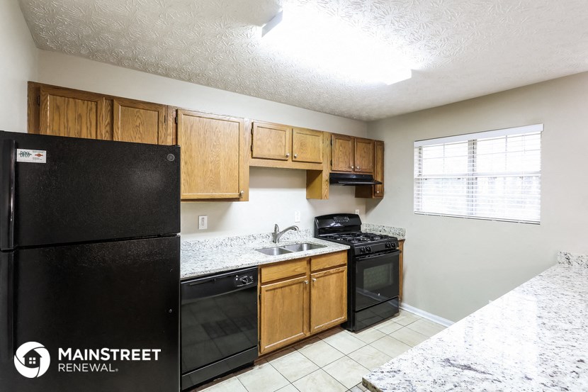 a kitchen with black appliances and wooden cabinets