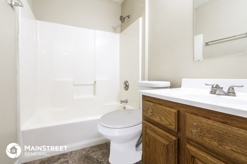 a bathroom with a toilet and a sink and a bath tub
