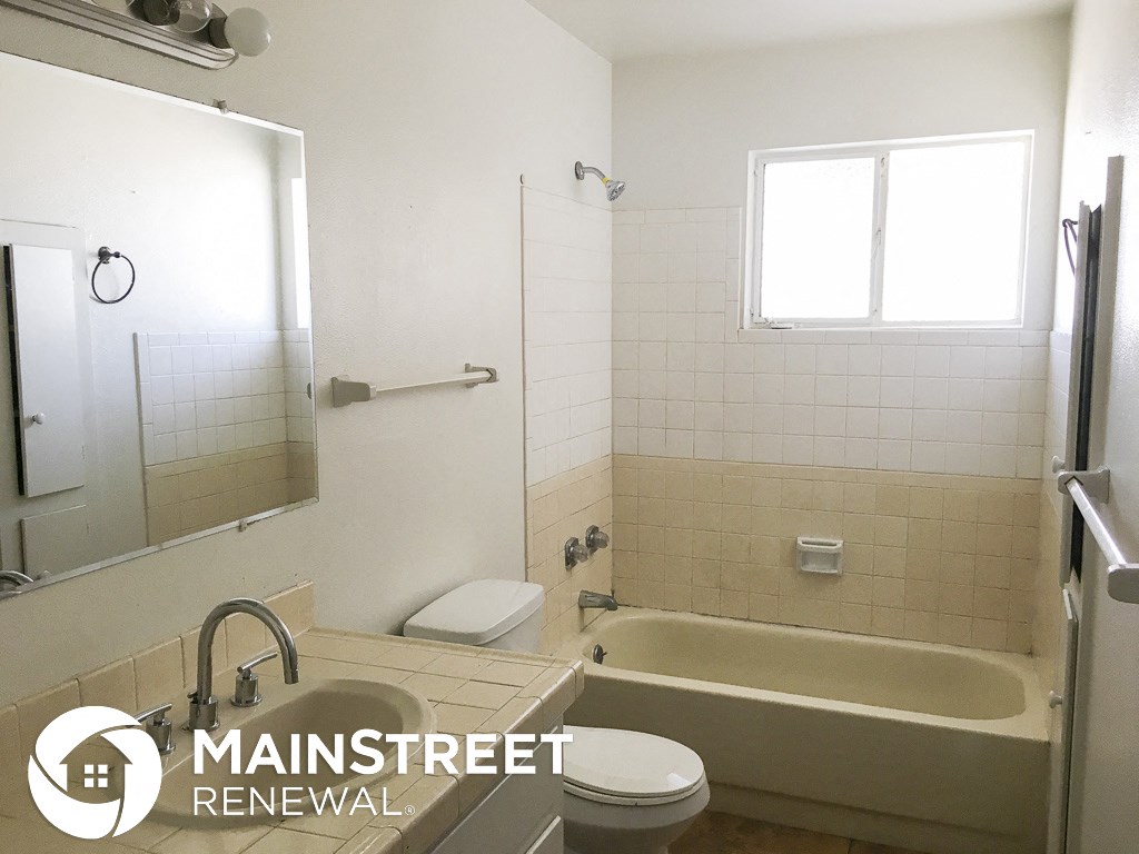 a small bathroom with a tub and a toilet and a sink