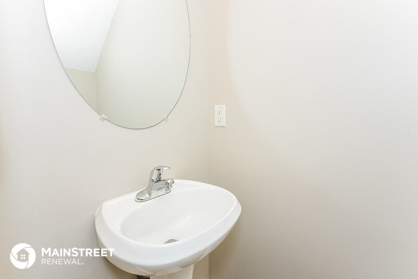 a small bathroom with a sink and a mirror